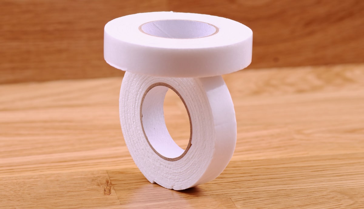 Two white tape rolls with transfer adhesives
